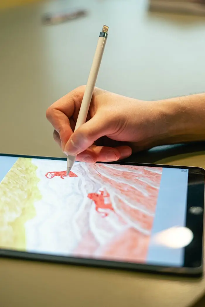 Close-up of hand drawing on tablet screen with stylus, showcasing digital artistry.
